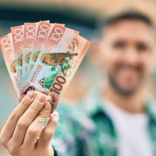 Man holding cash after selling his car in Whakatane